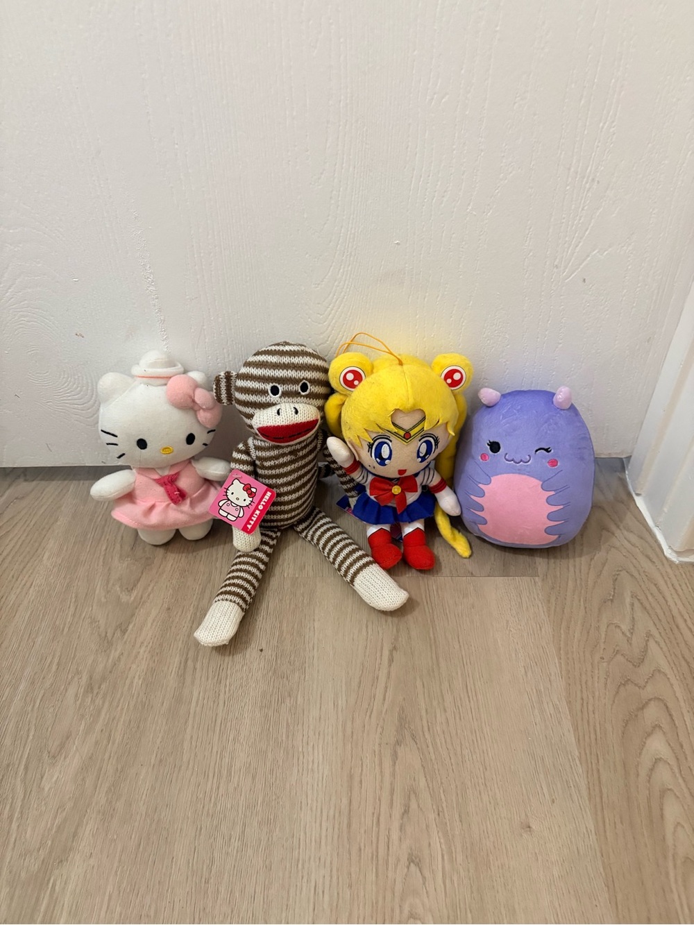 Four stuffed plushes Sailor Moon hello kitty squish mallow sock monkey